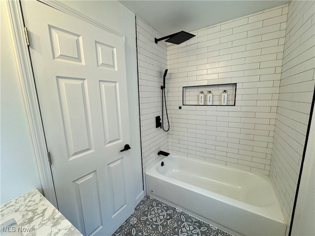 bathroom featuring vanity and tiled shower / bath