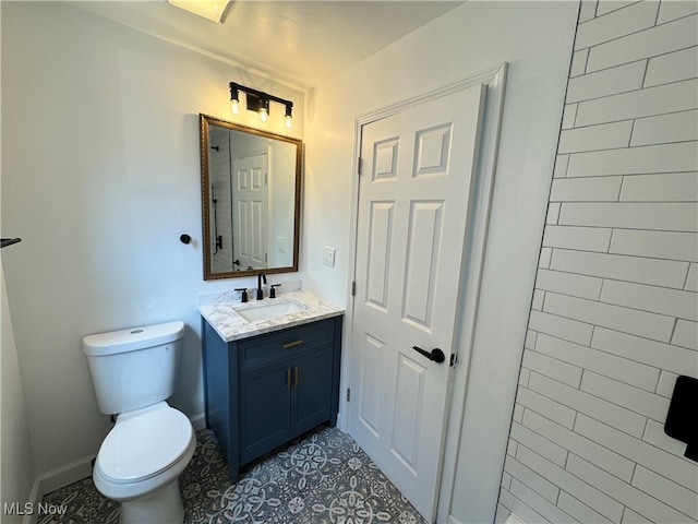 bathroom with vanity, toilet, and tile patterned floors