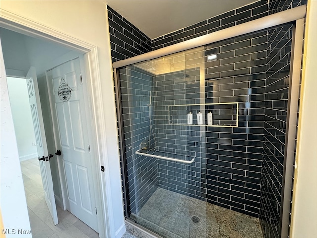 bathroom with a shower with shower door