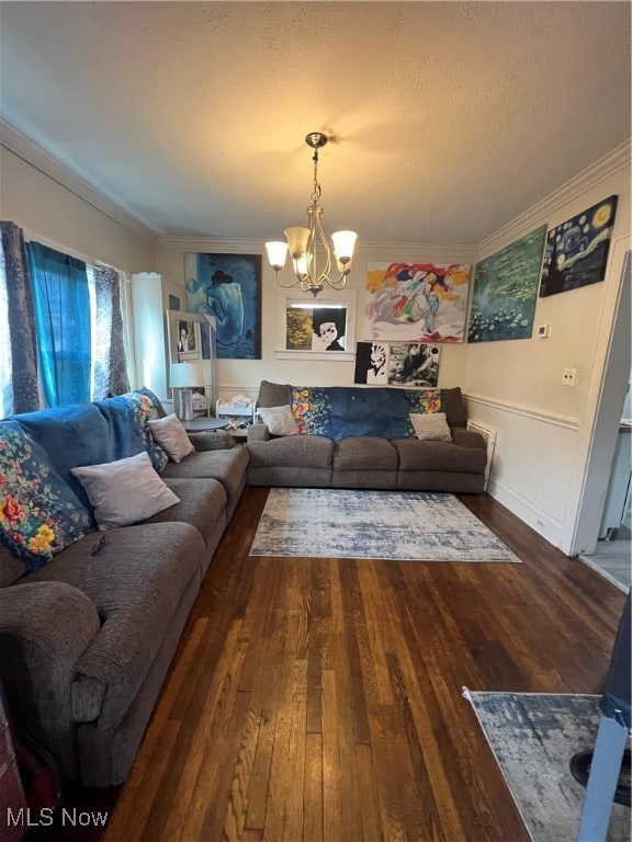 living room with a chandelier, crown molding, and dark hardwood / wood-style flooring