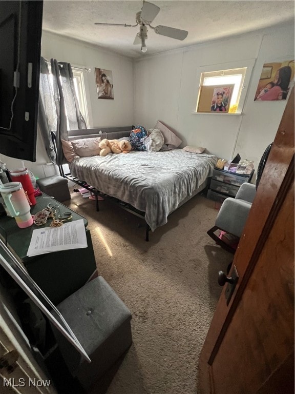 bedroom featuring carpet floors, multiple windows, and ceiling fan