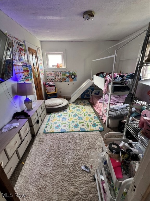 bedroom featuring a textured ceiling and carpet