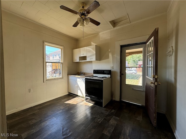 kitchen featuring white cabinetry, wood walls, dark hardwood / wood-style flooring, white electric stove, and ceiling fan