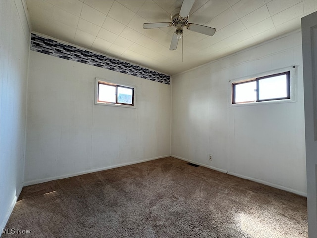 carpeted spare room featuring ceiling fan