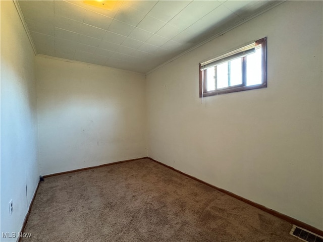 spare room with ornamental molding and carpet flooring