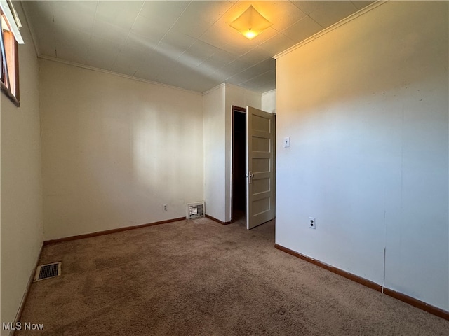 carpeted spare room with crown molding