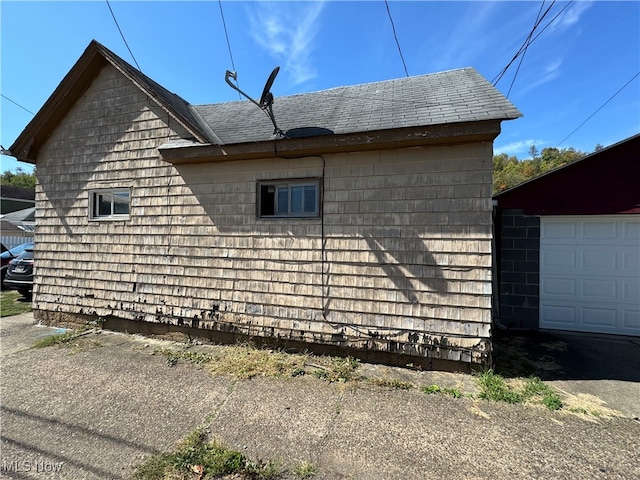 view of side of property featuring an outbuilding and a garage