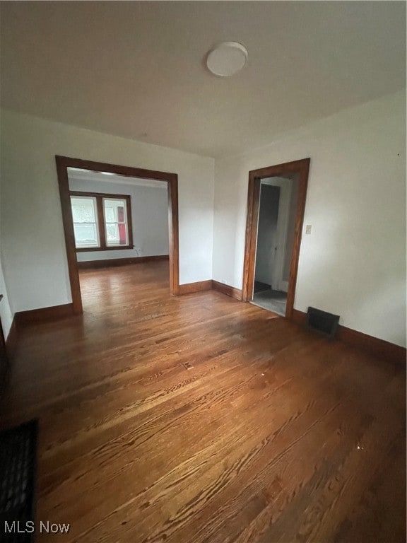 empty room featuring dark hardwood / wood-style flooring