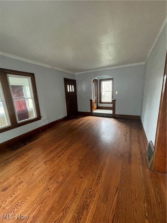 interior space with ornamental molding and hardwood / wood-style flooring