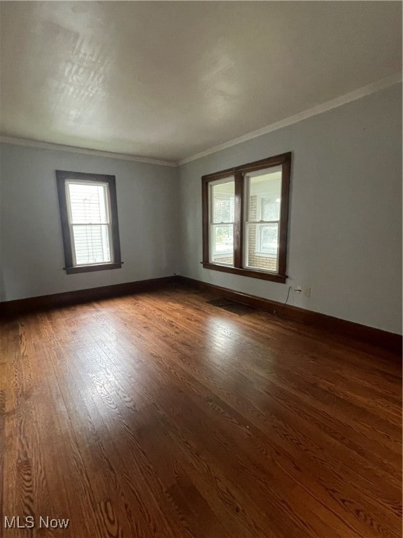 unfurnished room with dark hardwood / wood-style floors and crown molding