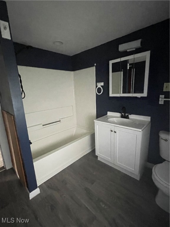 bathroom featuring wood-type flooring, vanity, and toilet