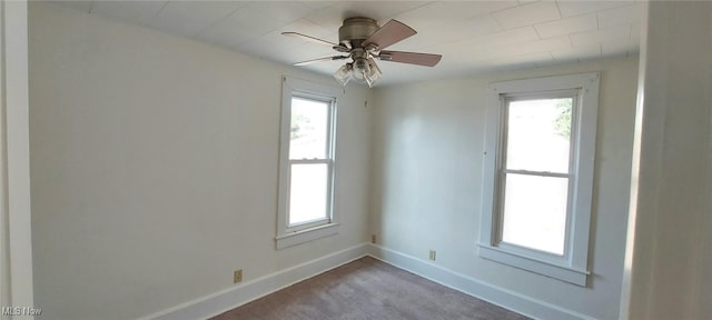 empty room featuring ceiling fan and carpet floors