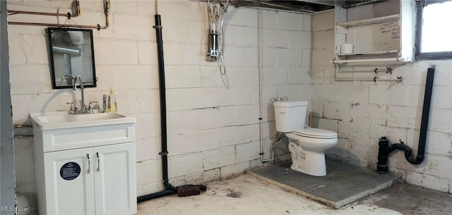 bathroom with vanity, toilet, and concrete floors