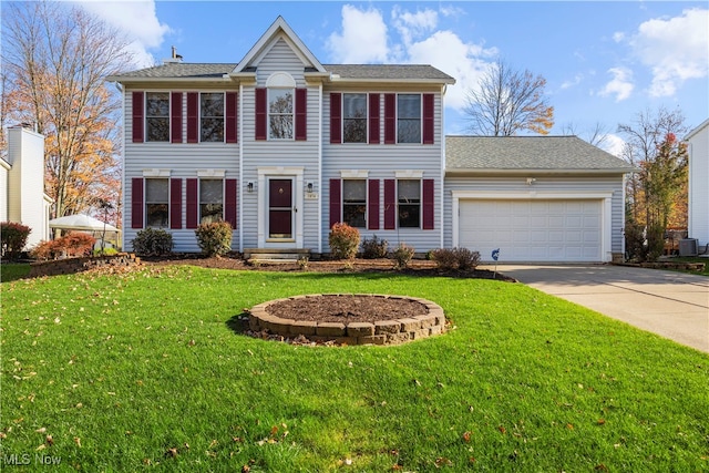 colonial home with central AC, a garage, and a front lawn