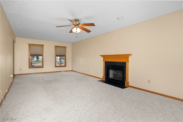 unfurnished living room featuring light carpet and ceiling fan