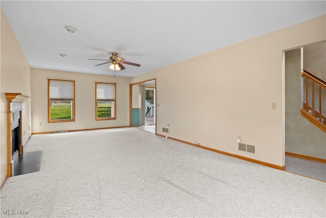 unfurnished living room featuring ceiling fan and light carpet