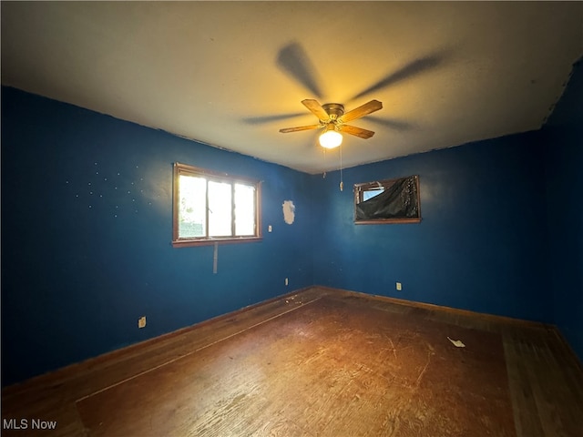 empty room featuring ceiling fan and hardwood / wood-style flooring