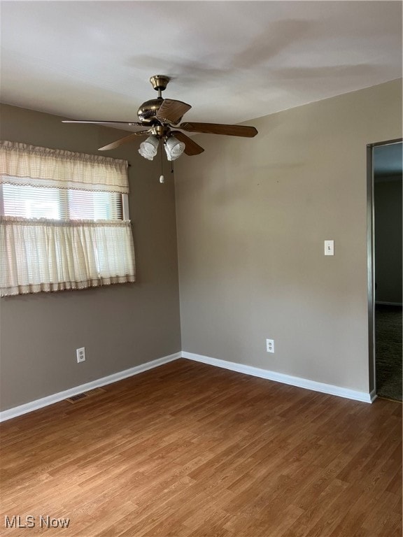 empty room featuring ceiling fan and hardwood / wood-style flooring