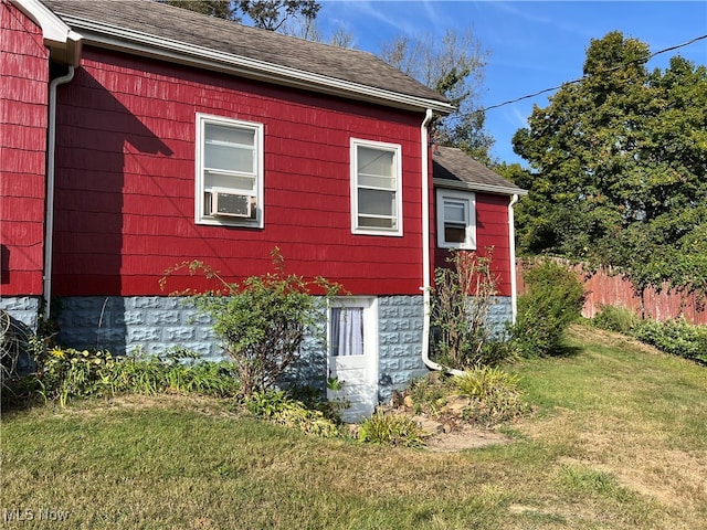 view of home's exterior featuring a lawn and cooling unit