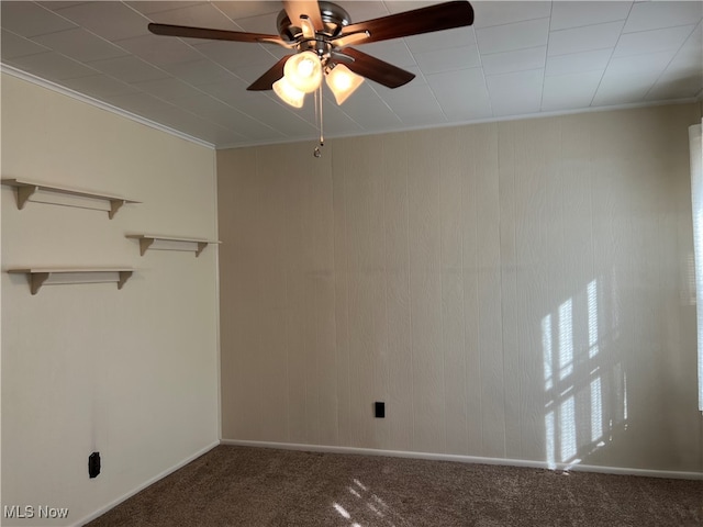 spare room with ceiling fan, carpet floors, and crown molding