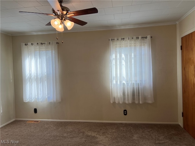 carpeted empty room featuring ornamental molding and ceiling fan