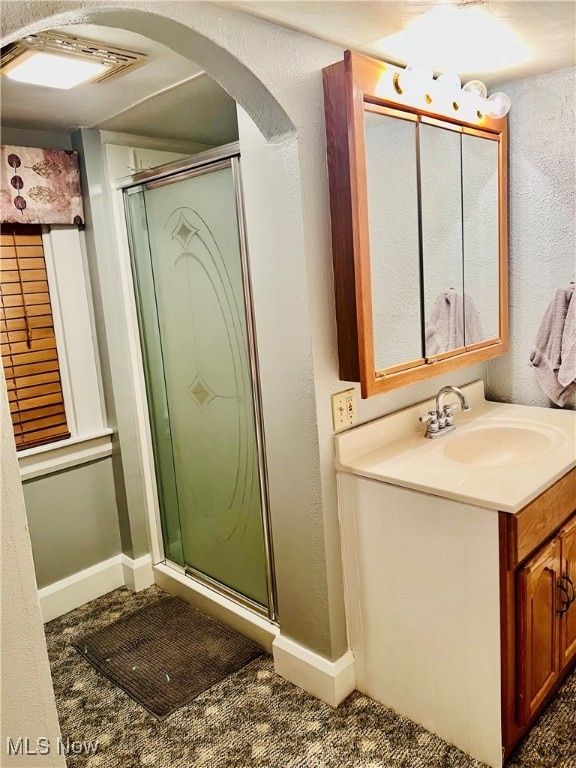 bathroom featuring vanity and an enclosed shower