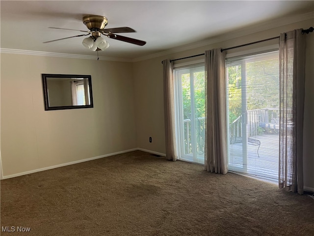 spare room with dark colored carpet, ceiling fan, and crown molding