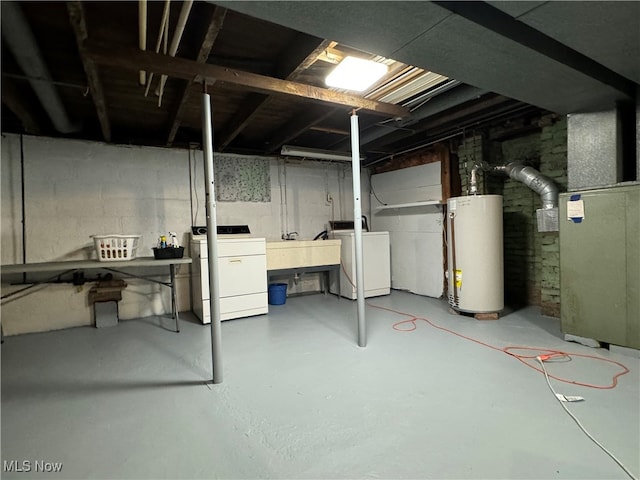 basement featuring water heater and washing machine and clothes dryer