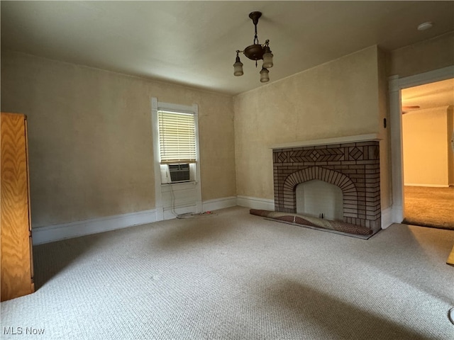 unfurnished living room with a brick fireplace, cooling unit, a chandelier, and carpet flooring