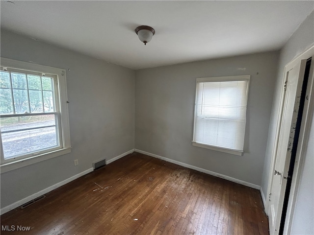 empty room featuring dark hardwood / wood-style flooring