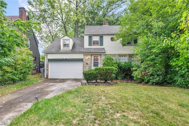 view of front of home featuring a front yard and a garage