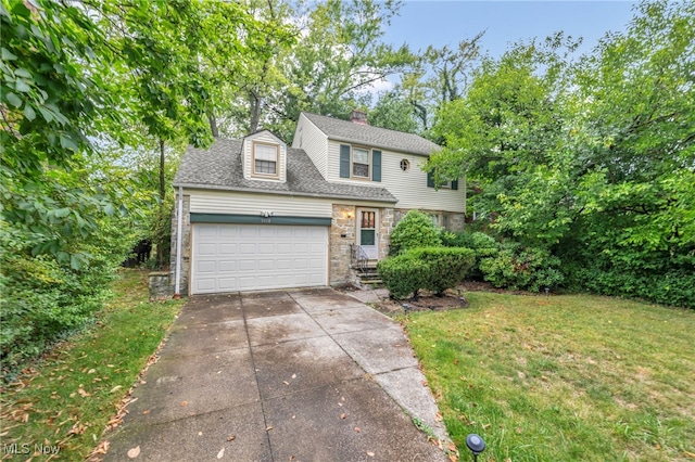 view of property with a garage and a front lawn