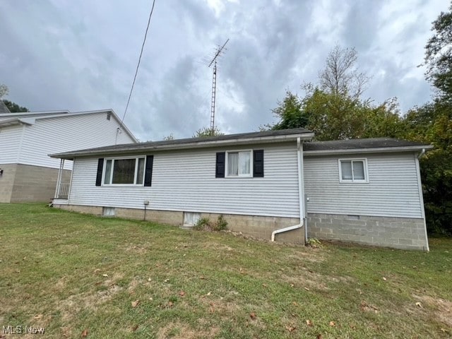 rear view of property with a yard