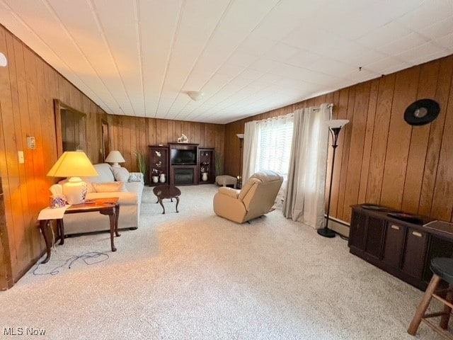 carpeted living room with wooden walls and baseboard heating