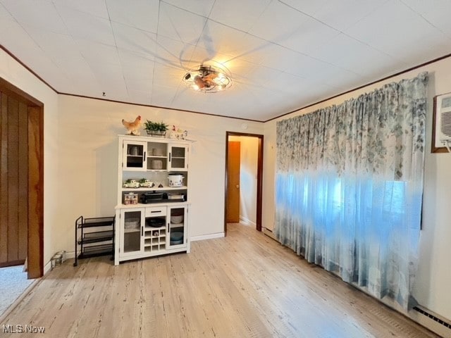 unfurnished room with light hardwood / wood-style flooring and a baseboard radiator