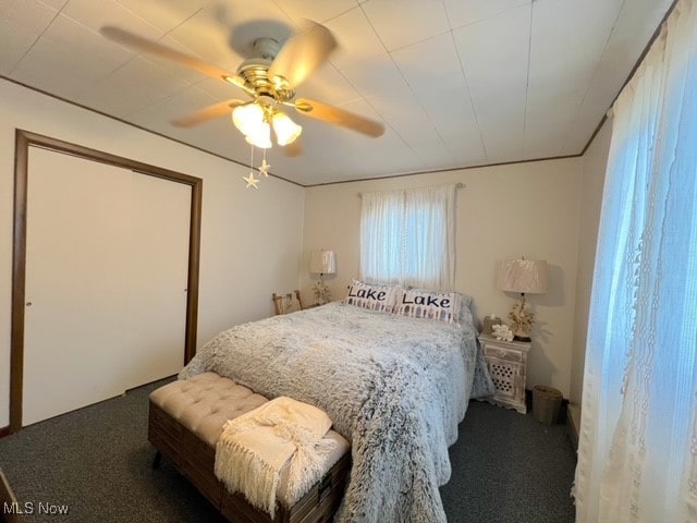 carpeted bedroom with ceiling fan