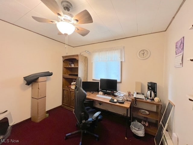 carpeted office space featuring ceiling fan