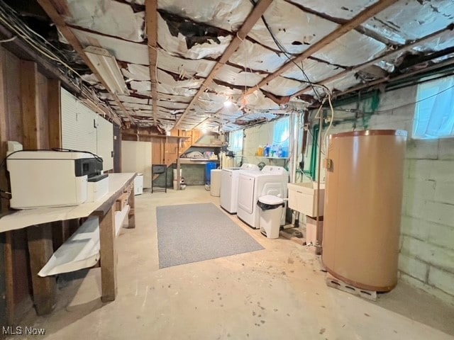 basement featuring gas water heater and washer and dryer