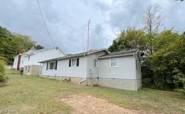 rear view of property with a yard