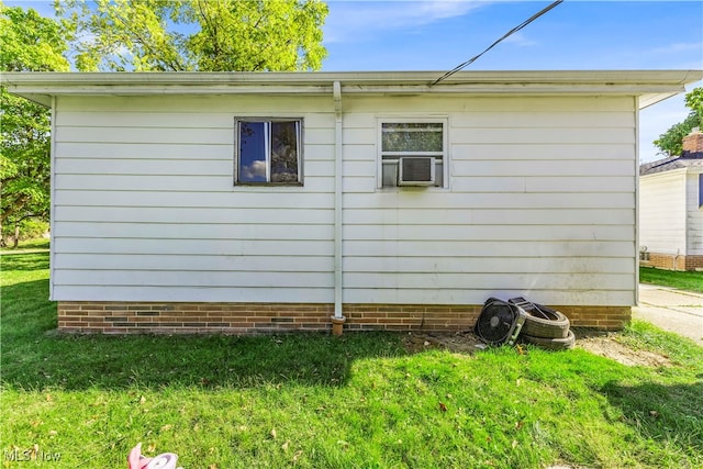 view of home's exterior featuring a lawn and cooling unit