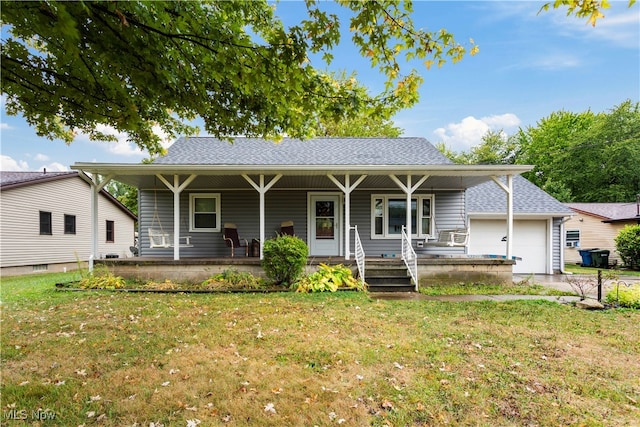 view of front of property featuring a garage, a front yard, and covered porch