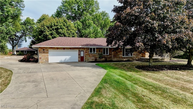 ranch-style home with a garage and a front yard