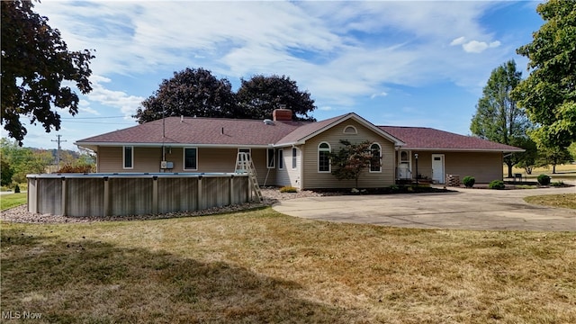 view of front of house with a patio and a front lawn