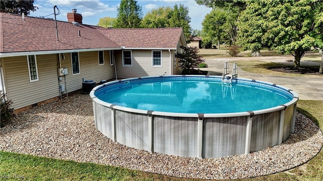 view of pool with central air condition unit