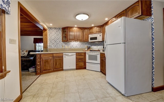 kitchen with white appliances, light tile patterned floors, and tasteful backsplash