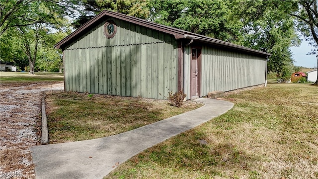 view of outdoor structure featuring a lawn