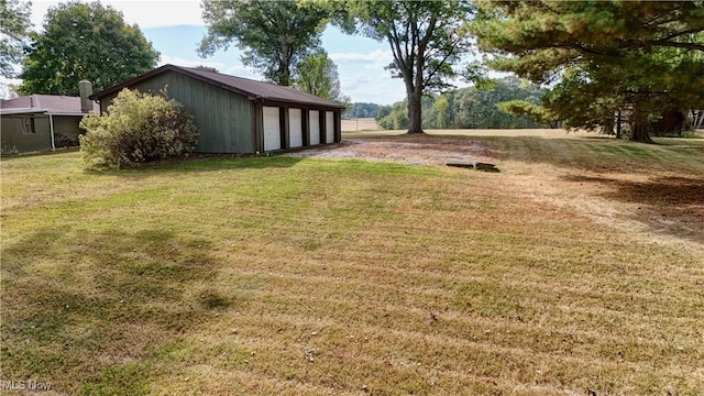 view of yard featuring an outbuilding and a garage