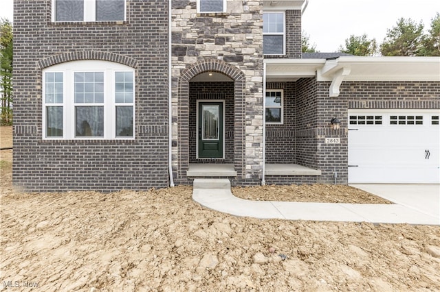 view of exterior entry featuring a garage