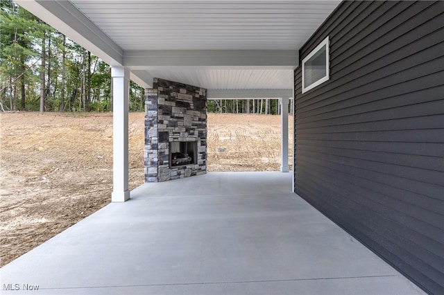 view of patio with an outdoor stone fireplace