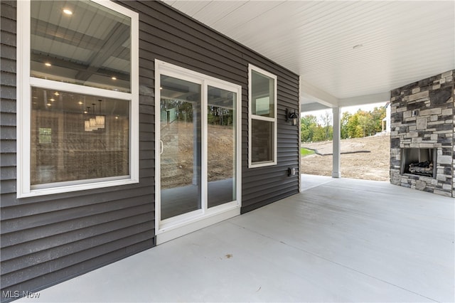 view of patio / terrace with an outdoor stone fireplace